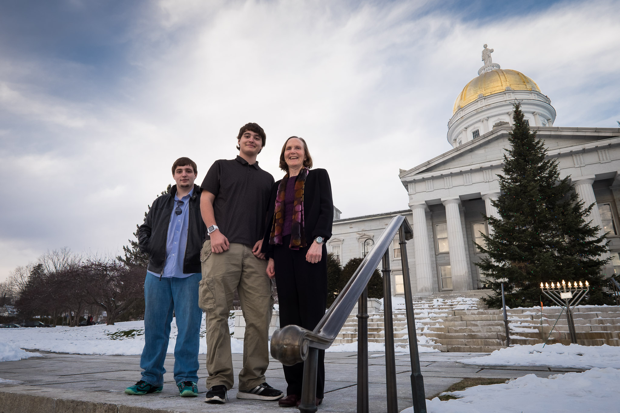 Justin, center, at the State House with his brother Brandin and President Judy in 2016 to represent the Man Up program.