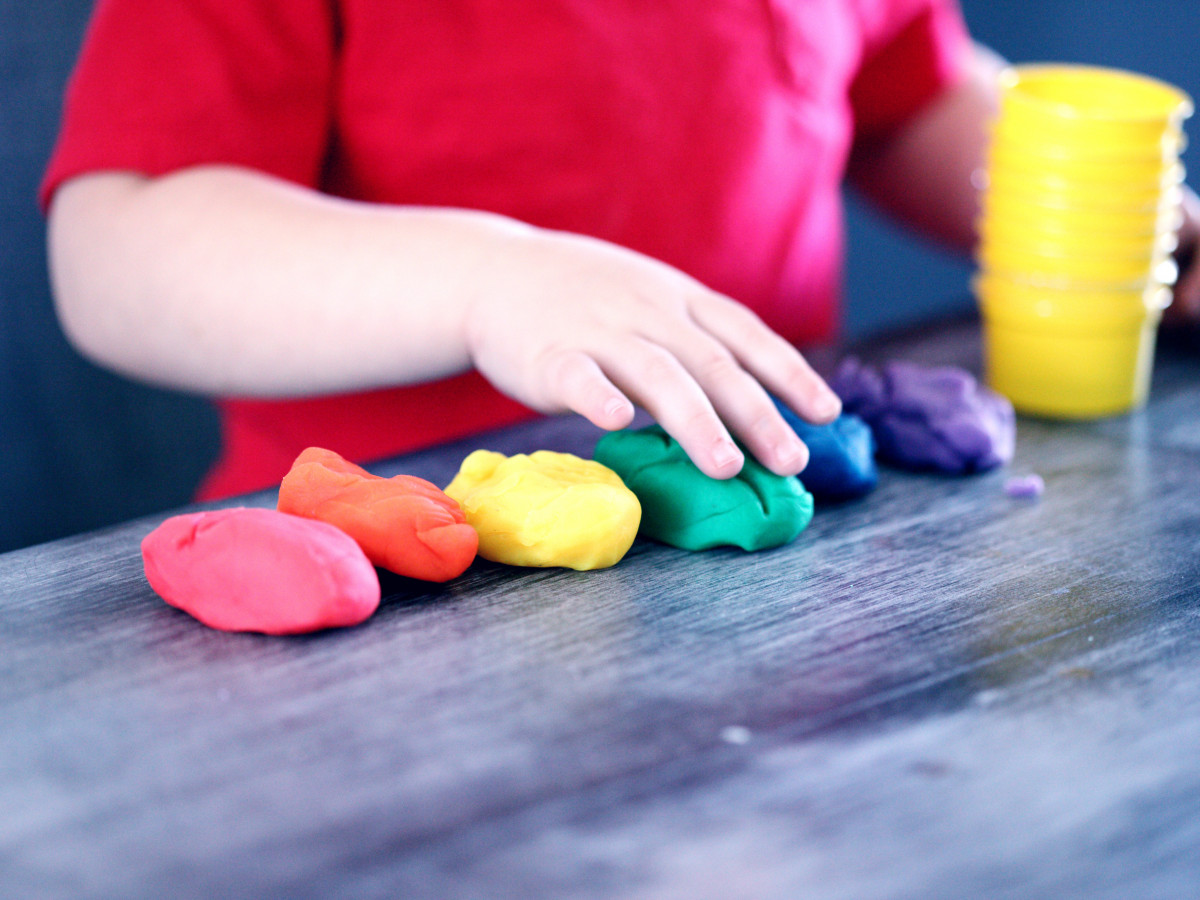 Child playing with colored dough