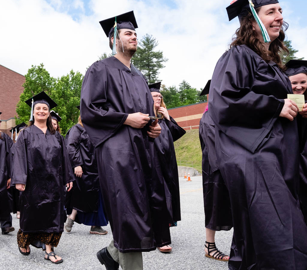 Graduates in cap and gown walking