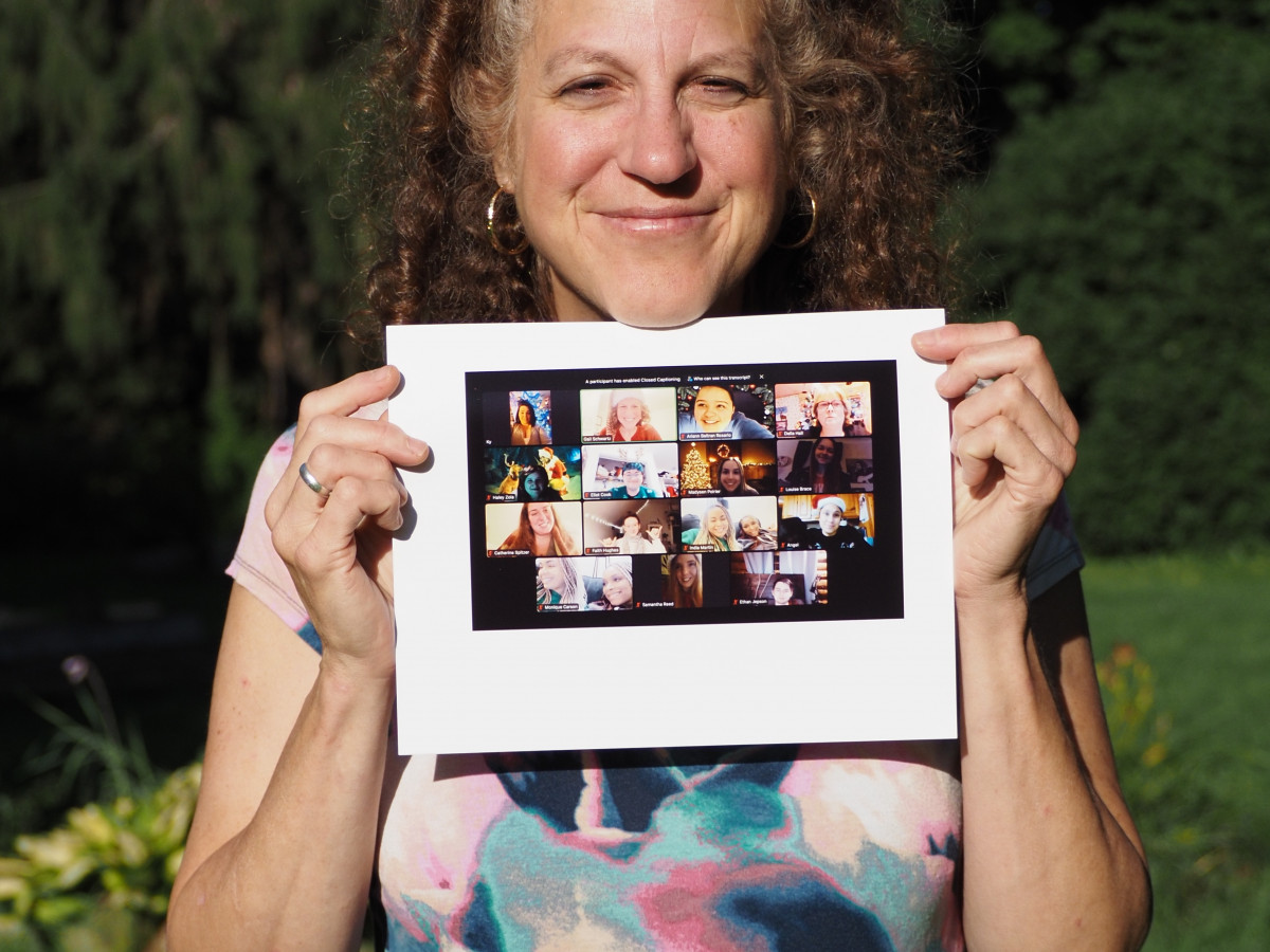 Gail Marlene Schwartz holding a class photo
