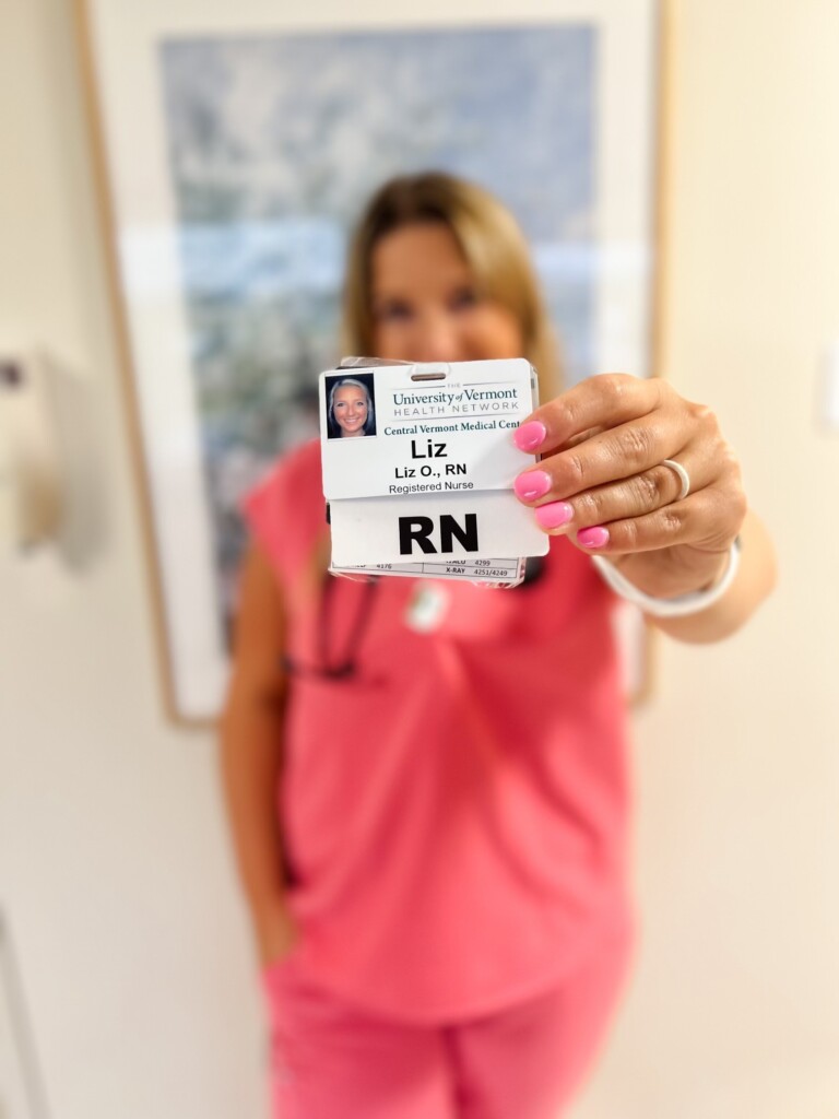 Liz O'Connell holding RN badge