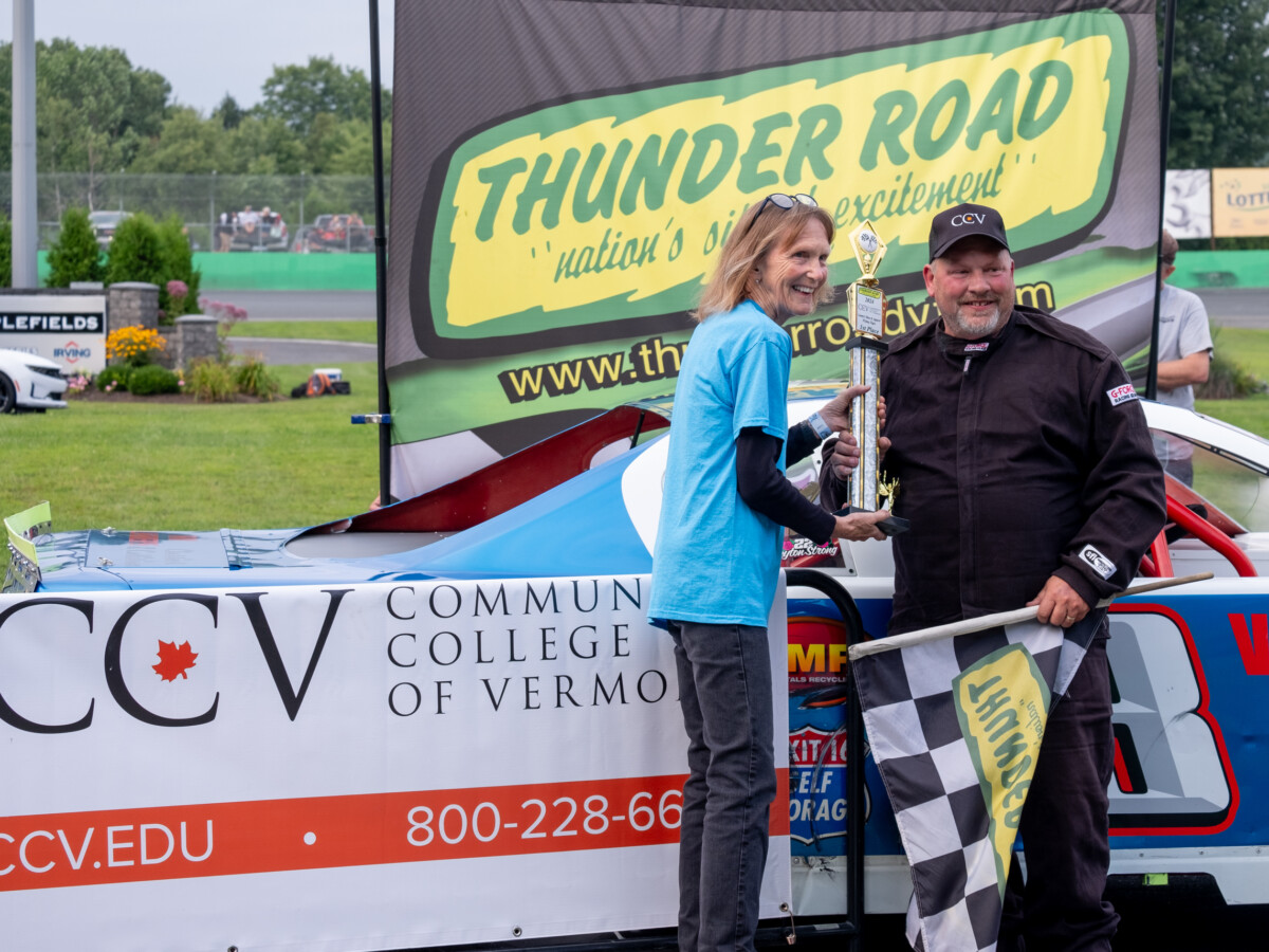 Joyce Judy handing trophy to driver at Thunder Road