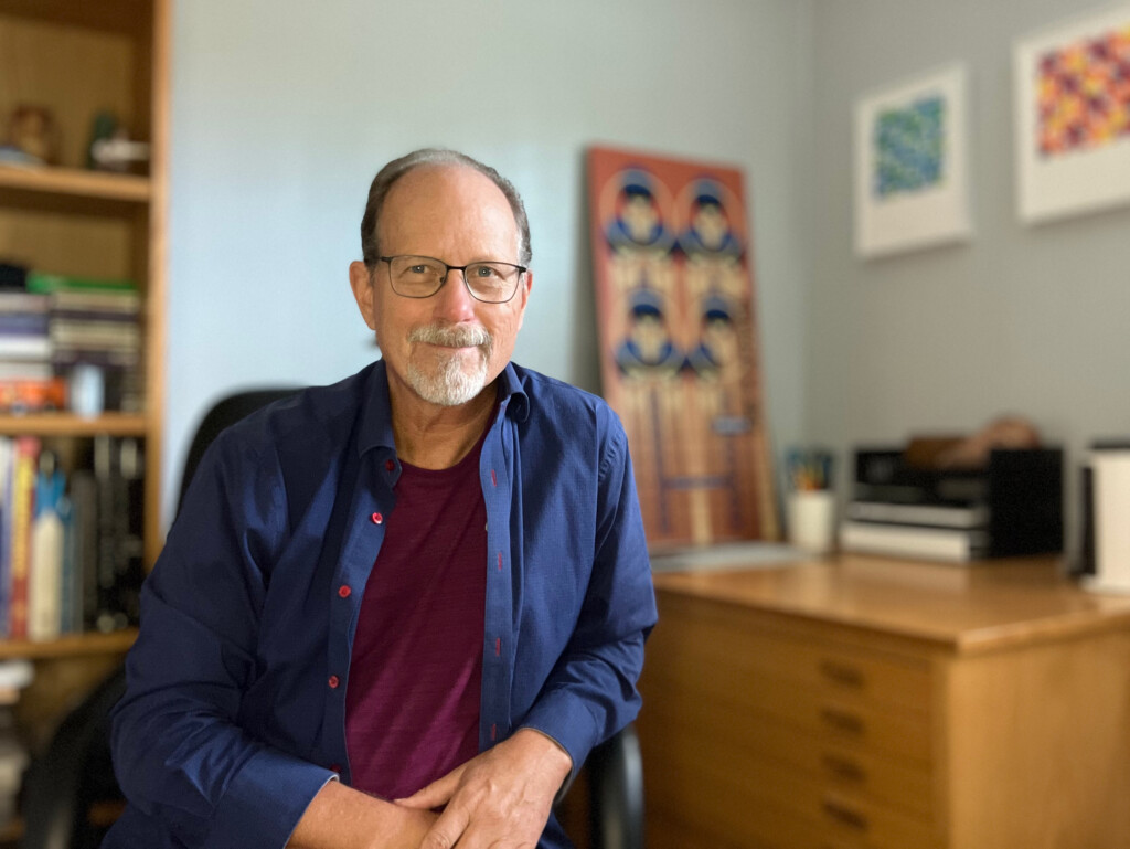 Faculty member Robert Kirk sitting in his office.