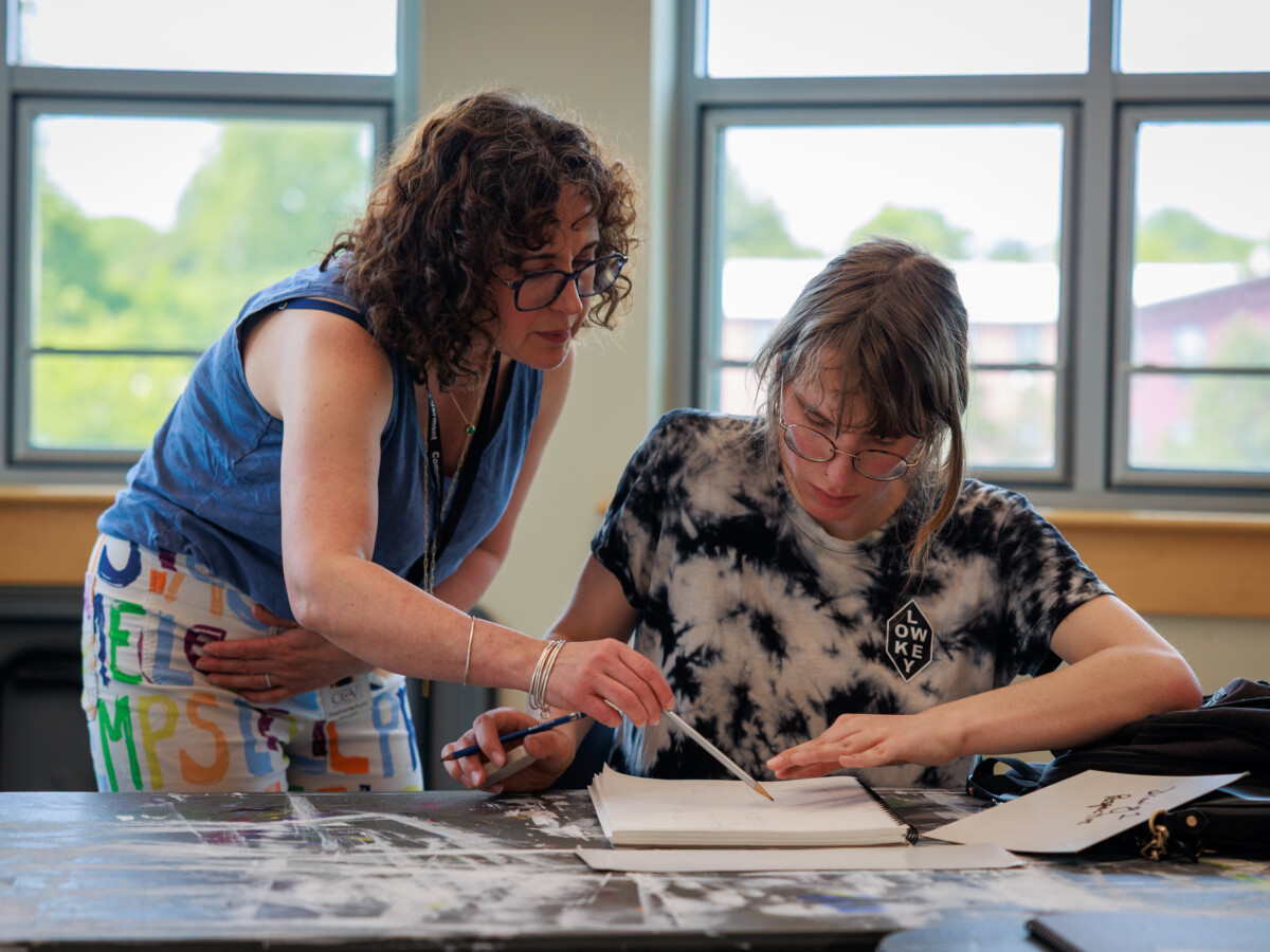 Art teacher talking with student