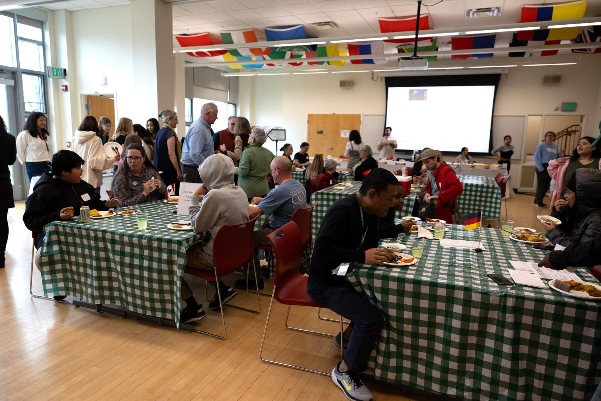 Crowd seated and talking in Janice Couture room