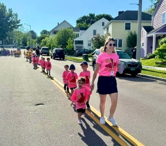 Sophie walks with preschool students.