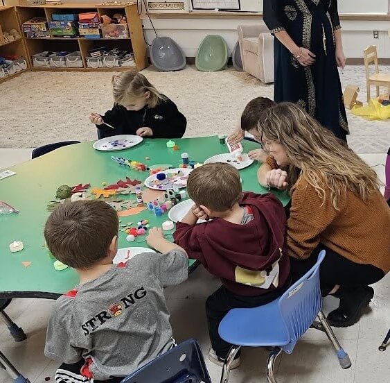 Sophie works with students in the classroom.