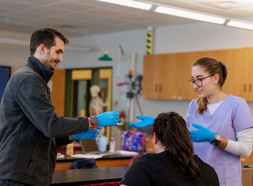 Three students in clinical medical assisting lab