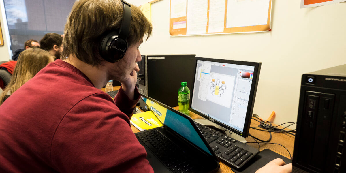 Student at computer in graphic design class