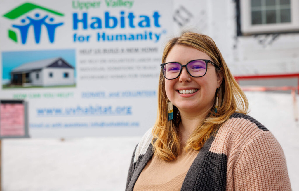 Ashley Andreas in front of a home being built for Habitat for Humanity.