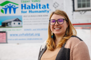 Ashley Andreas in front of a home being built for Habitat for Humanity.