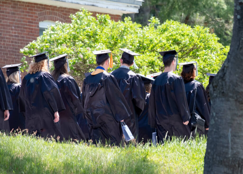 Graduates walking in caps and gowns
