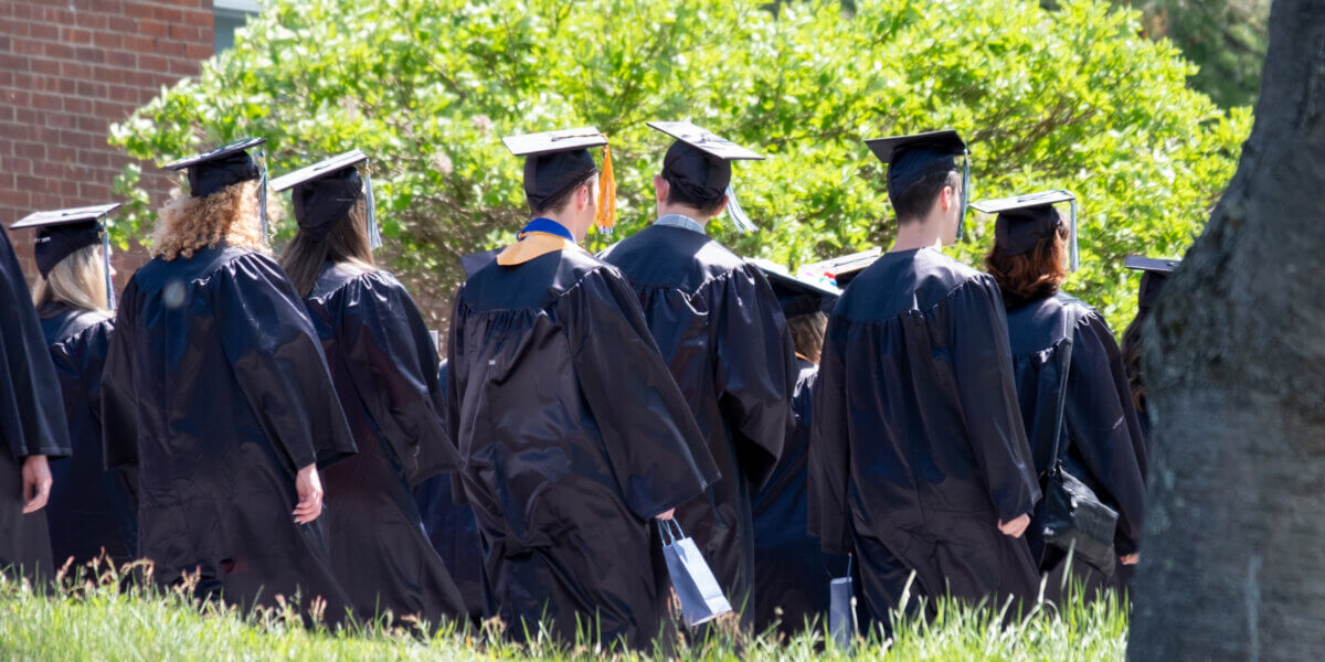 Graduates walking in caps and gowns