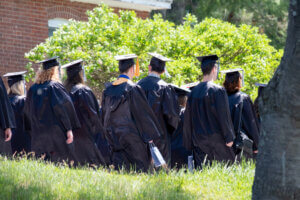Graduates walking in caps and gowns