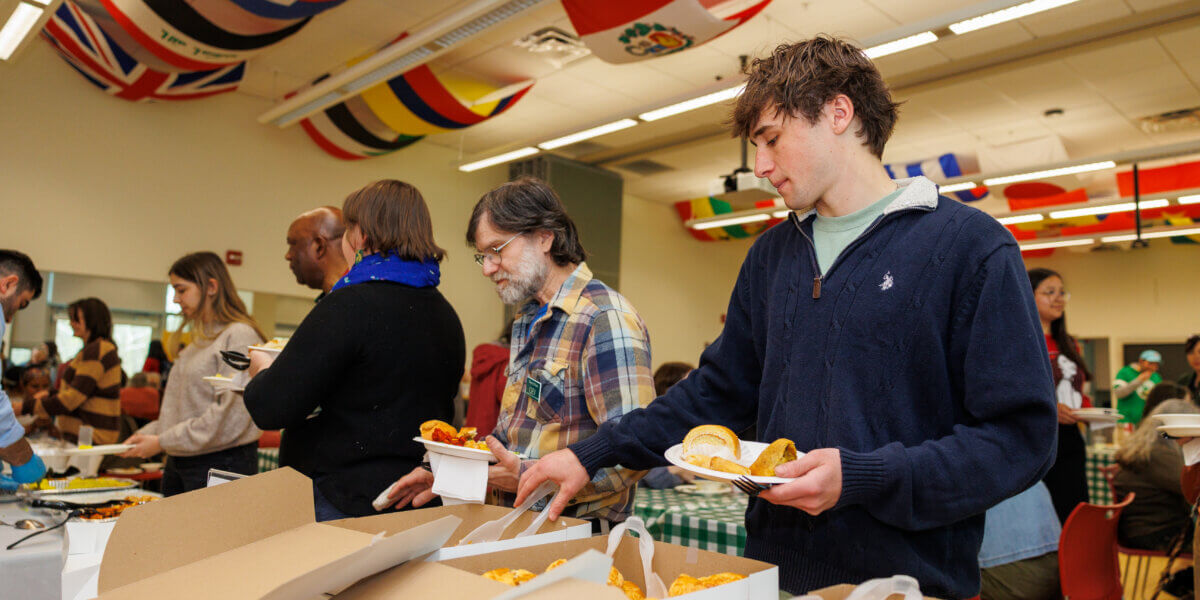 Students and faculty dishing up food at the International Food Festival.